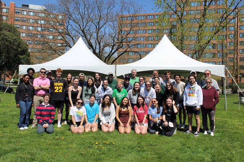 Student volunteers who provided free tax help pose for a photo under a tent outside on Loyola