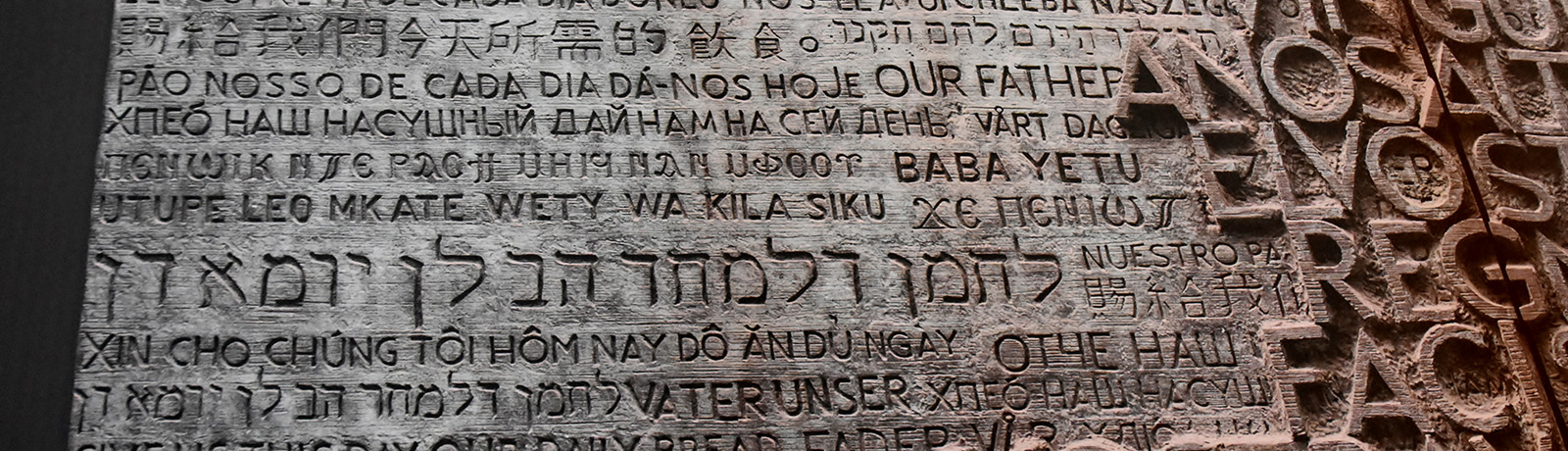 A stone slab with various languages etched into it