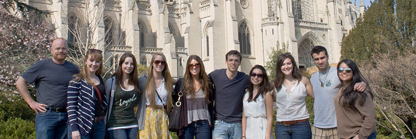 Students posing for a photo together in front of the National Cathedral