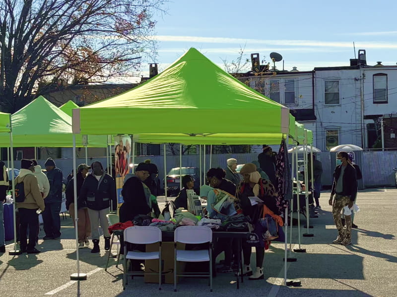 An outdoor health clinic in the York Road Corridor, where neighborhood residents stop by to receive information about health services.