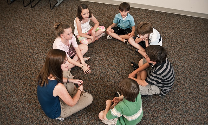 Children sitting in a circle on the floor