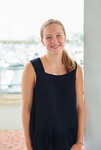 Photo of Bridget with a dock behind her 