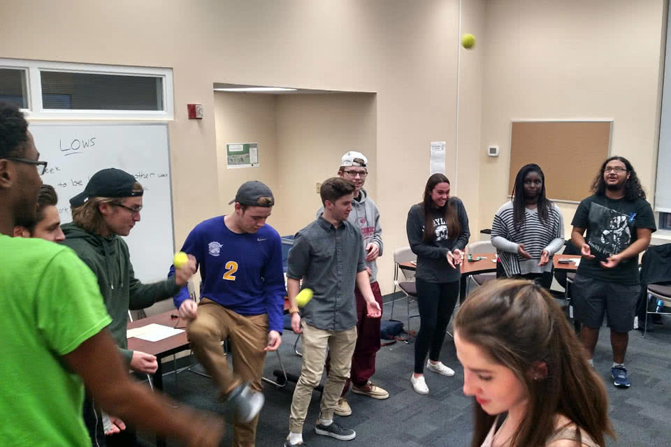 Students doing an activity with tennis balls