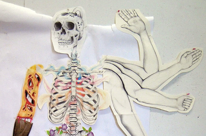 Cut-out drawings of human bones and arms that have been glued together to form a new image
