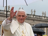 Pope Benedict XVI waves to a crowd in St. Peter's Square