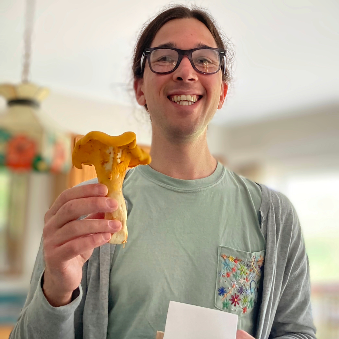 Rob Brosius headshot holding a mushroom 