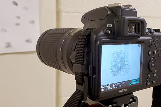 Forensic Science lab with camera featuring fingerprint