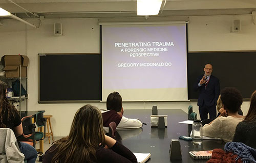 Dr. Gregory McDonald giving a presentation on forensic aspects of penetrating trauma