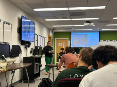 Alyssa Falcone presenting in front of a group of college students