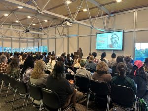 Brian Turner presenting to a group of large students