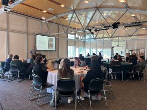 college students sitting at tables watching presentation