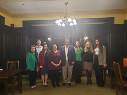 faculty posing for group photo after dinner