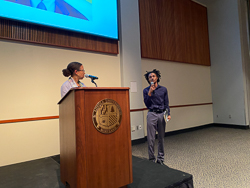 Izzy White presenting Rachel Swarns with book