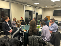 Faculty eating dinner around a table