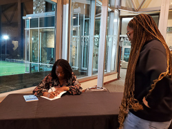 Teri Ellen Cross Davis signing a book