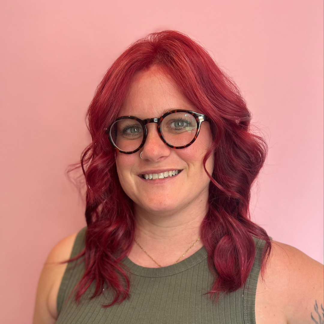 Headshot of Professor Heather Braxton with a pink background