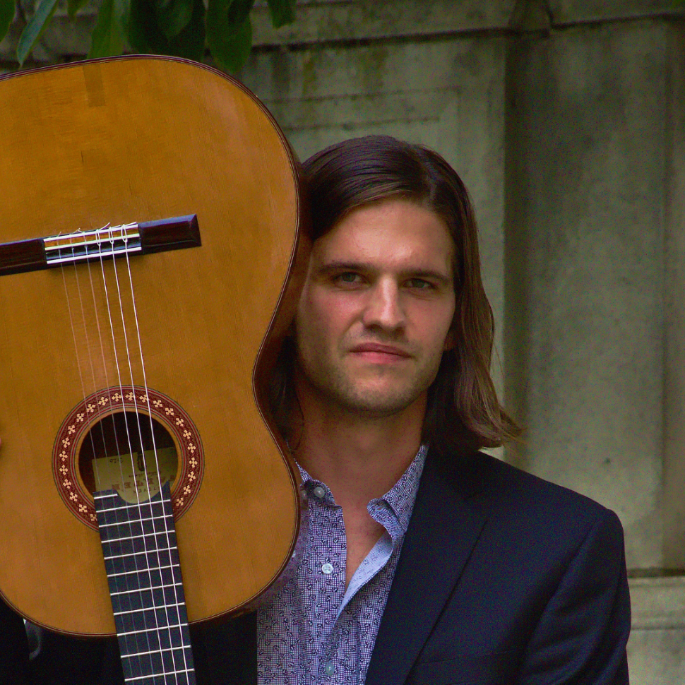 Ian Hrdlicka holding a guitar