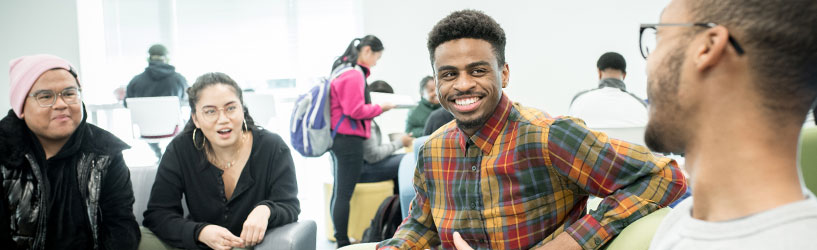 Students smiling in conversation at the Center for Intercultural Engagement (CIE)