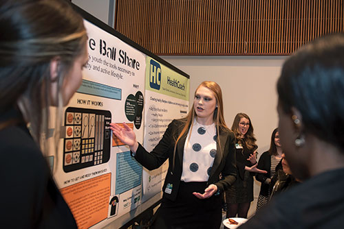 Student presenting project at research conference 