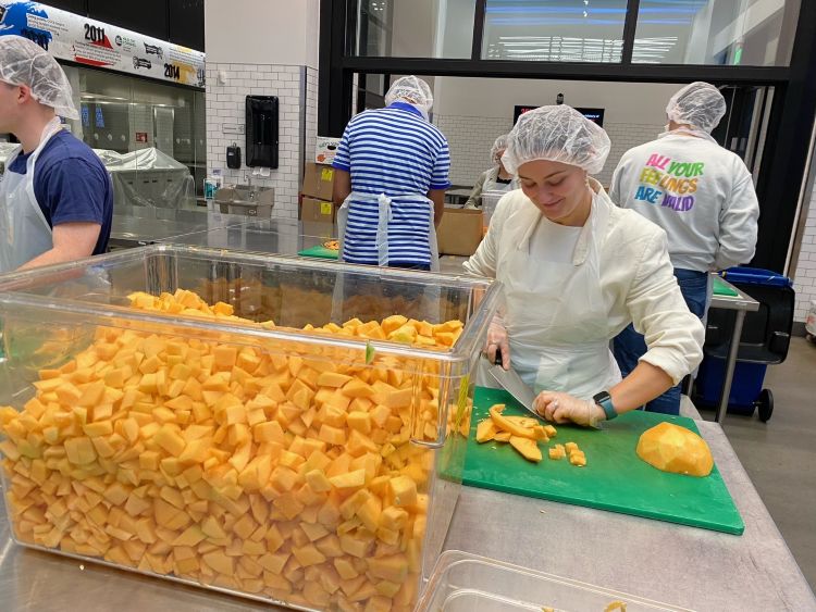 Loyola alumni prepare food in a kitchen during a Washington, D.C. Regional Network event