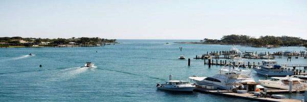 The Jupiter Inlet during the day with water skiiers and boaters on the water