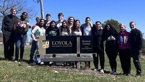 Students in front of the Loyola sign