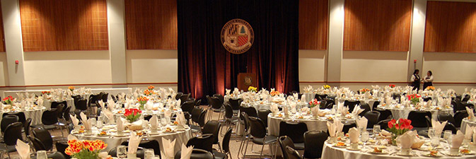 McGuire Hall featuring round banquet tables and a podium