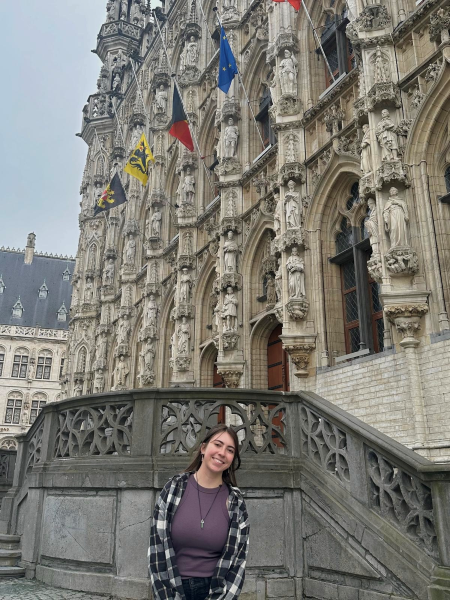 A girl standing in front of a cathedral