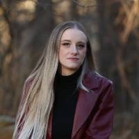 Sophia Bell wearing a red leather jacket