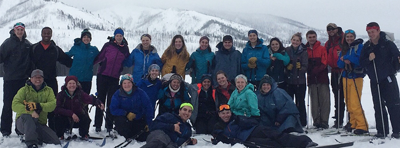 Outdoor Adventure Experience participants on top of snowy mountain
