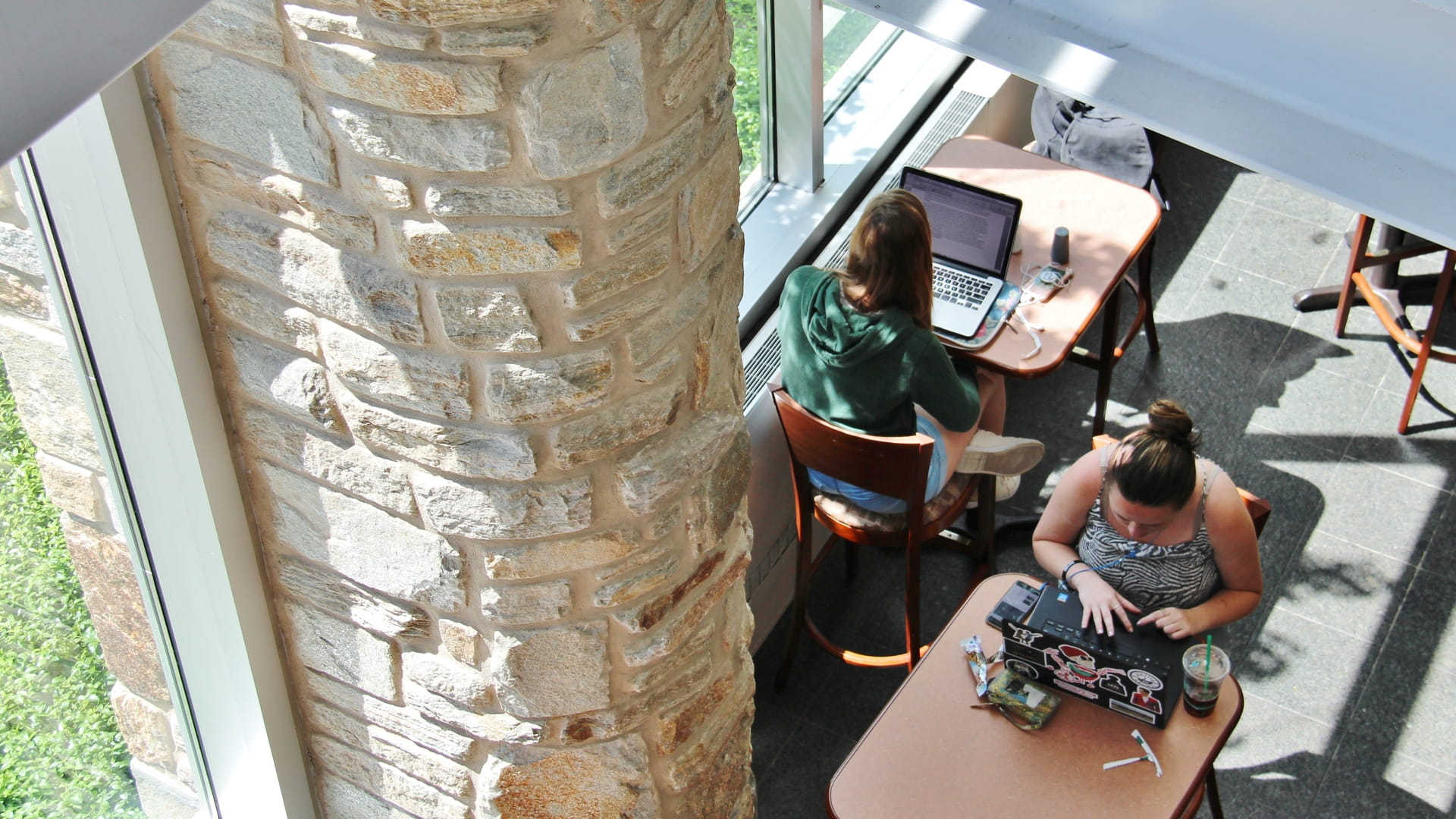 An overhead view of two students working in the student center