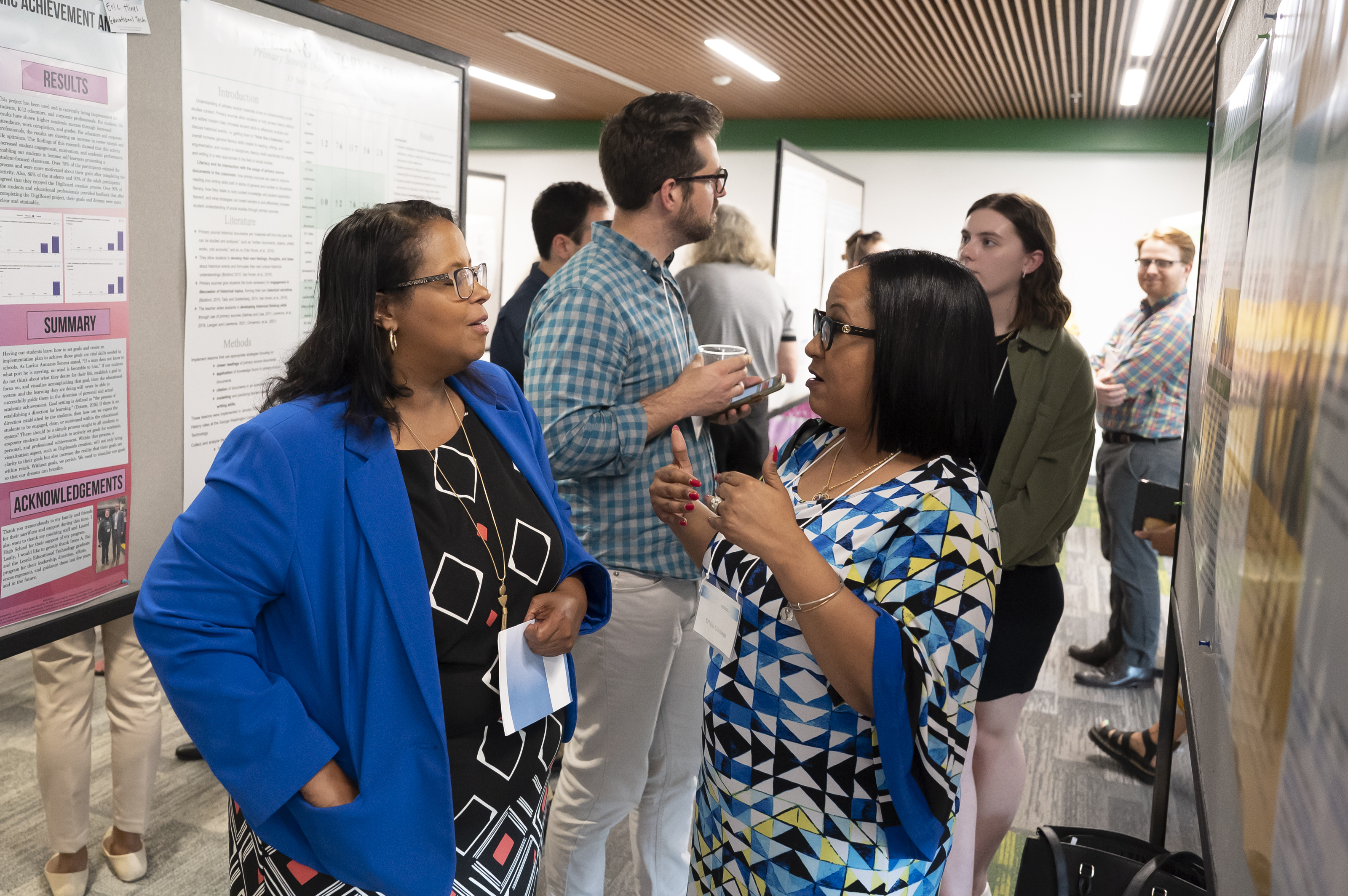 Two individuals discussing a poster at Emerging Scholars Celebration of Research, Loyola Univ. Maryland