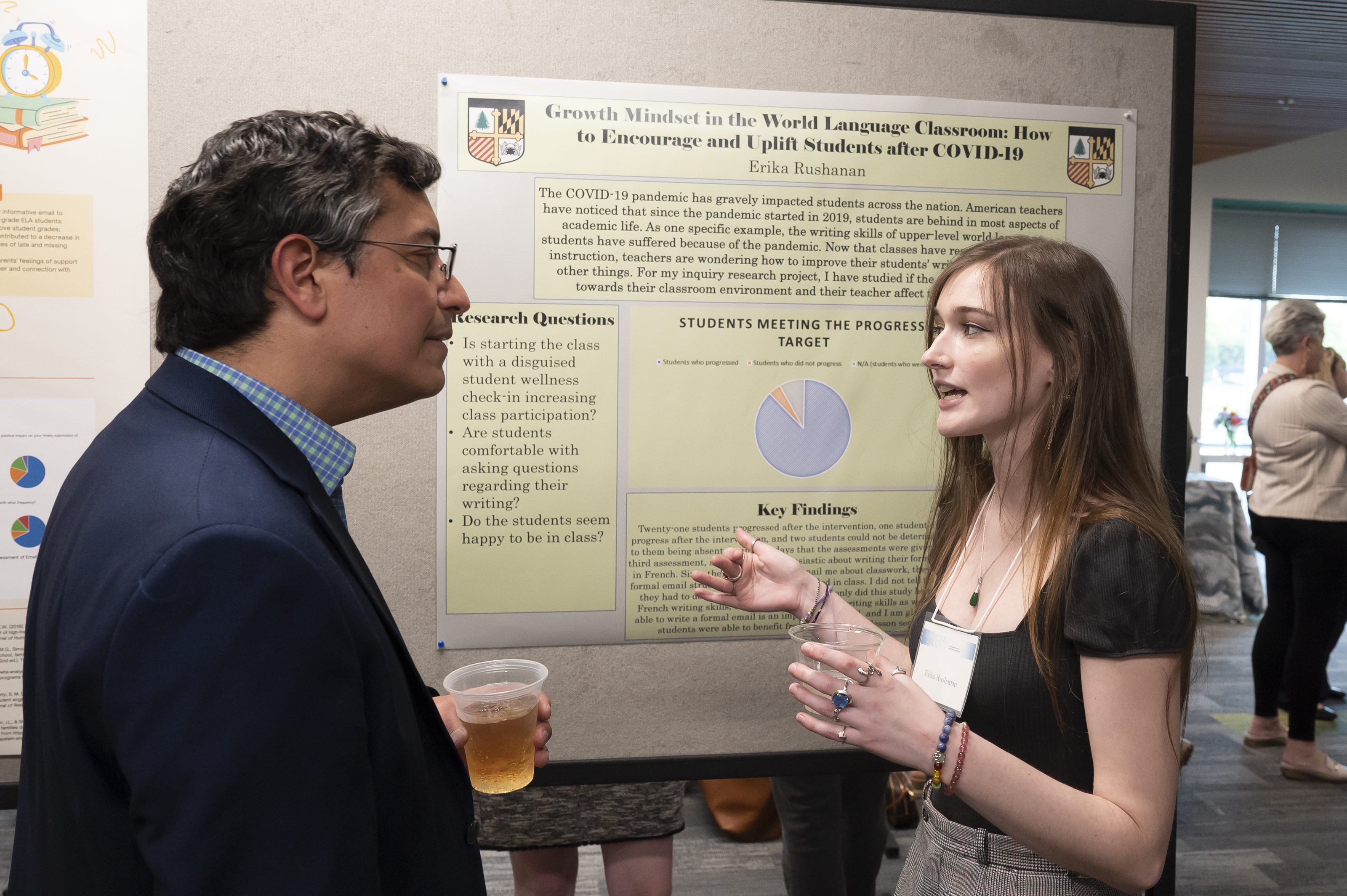 Presenter discusses poster with administrator at Emerging Scholars Loyola University Maryland