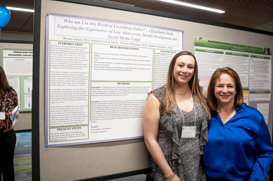 Presenter poses with family member in front of poster at Emerging Scholars 2024