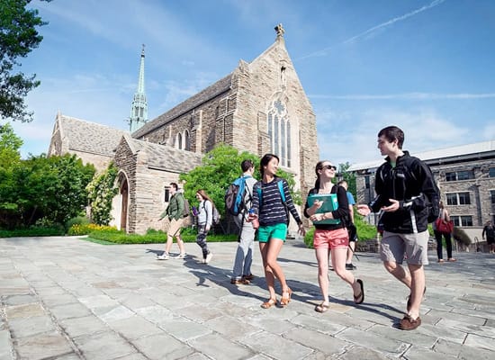 Students walk outside in front of the Alumni chapel