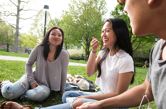 A group of students enjoy a spring day on the quad.