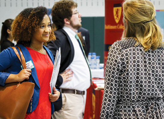 Students talk to recruiters during a career fair