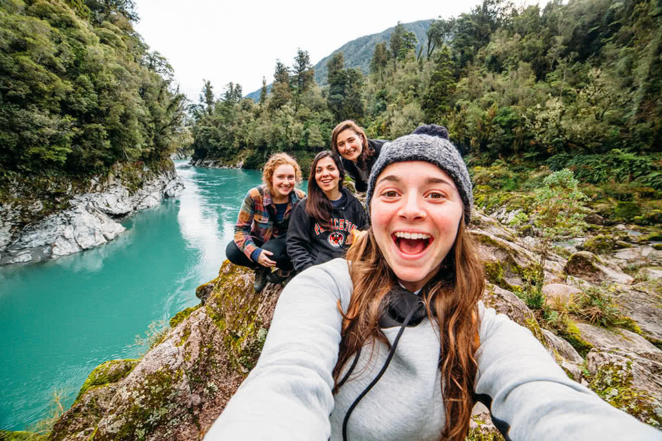 A selfie with 3 other studens along a river in New Zealand