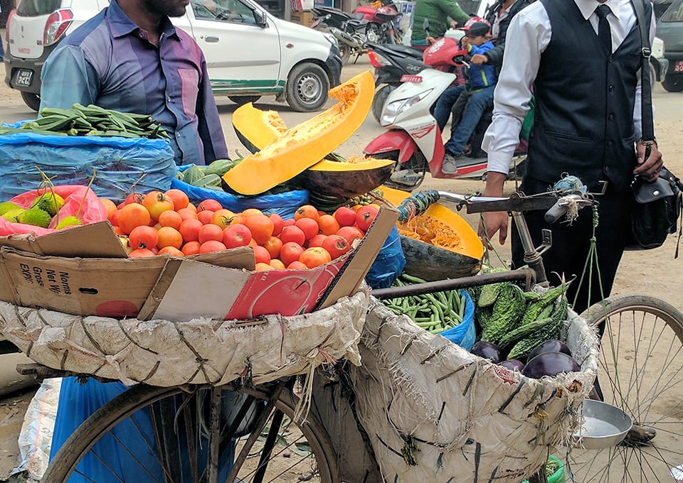 A man sells vegetables from his bicycle