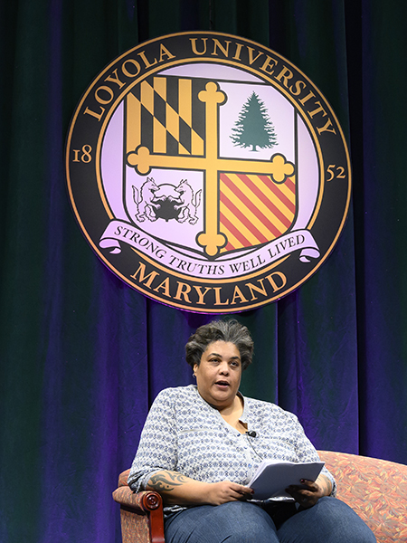 Roxane Gay seated on Loyola's stage.