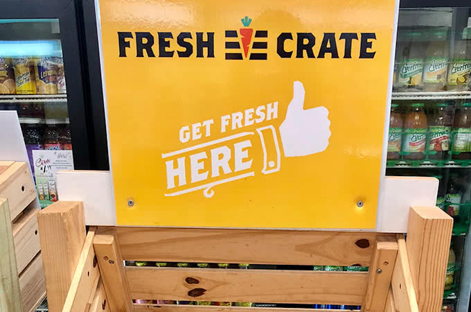 A sign that reads Fresh Crate - Get Fresh Here