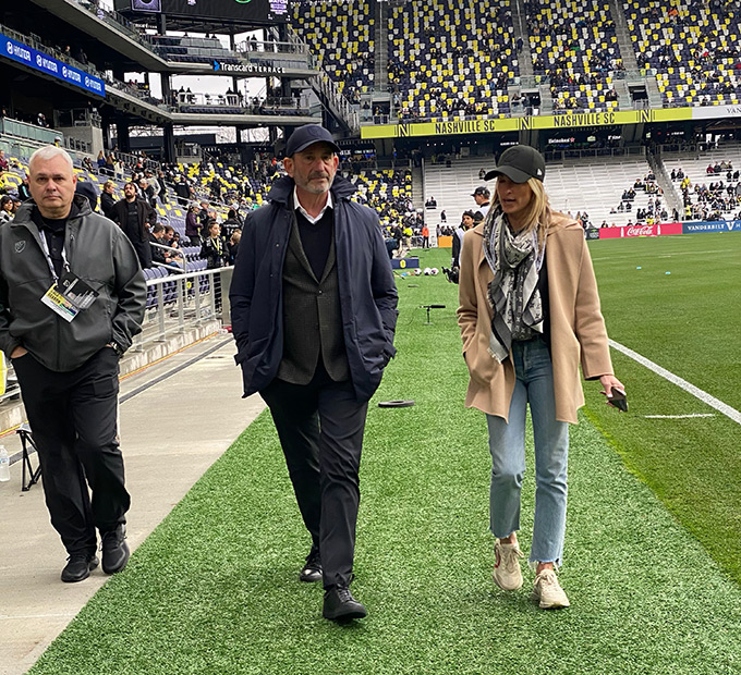 Nina Tinari walking and talking in a soccer stadium
