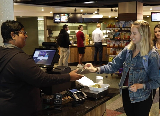Student paying for meal at Boulder Garden Cafe