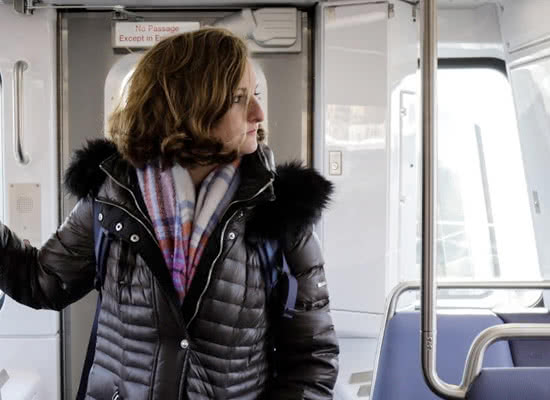 Margaret Wroblewski stands in an empty metro car looking to the side
