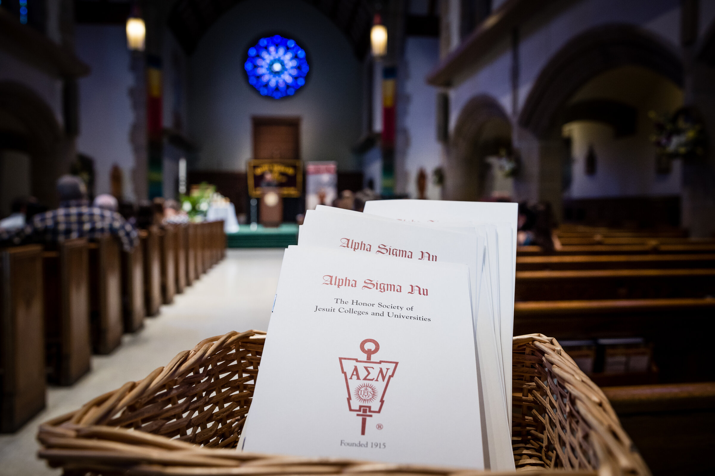Alpha Sigma Nu pamphlets placed in a woven basket 