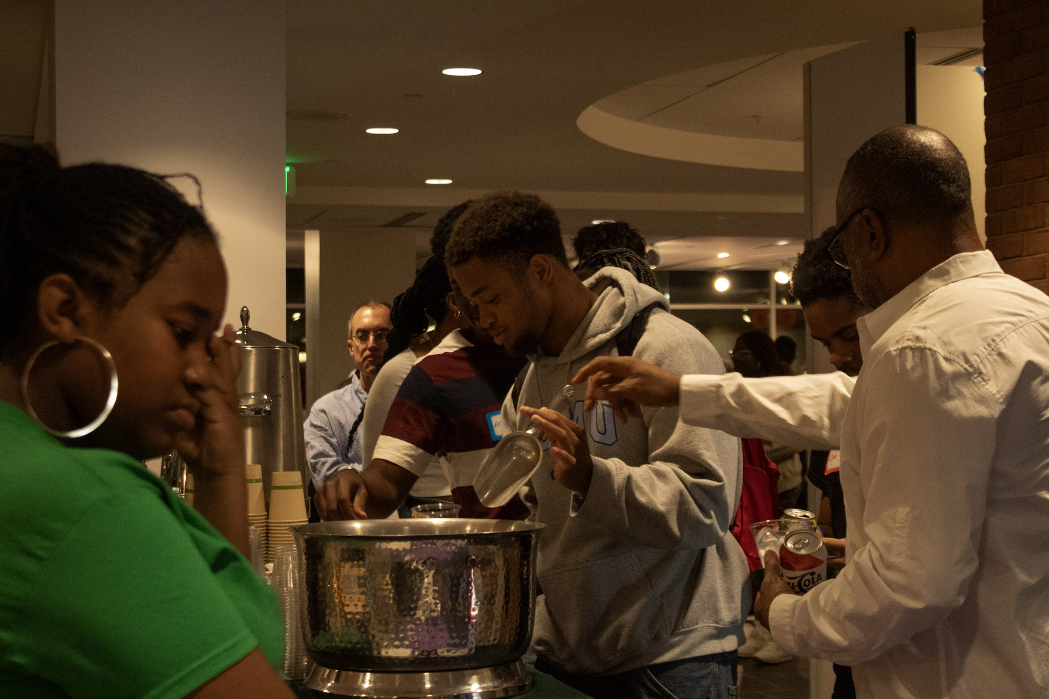 Attendees line up for refreshments in the library gallery