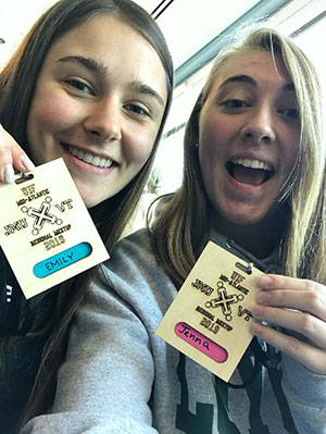 Emily Cebulski and Jenna Bower excitedly holding credentials