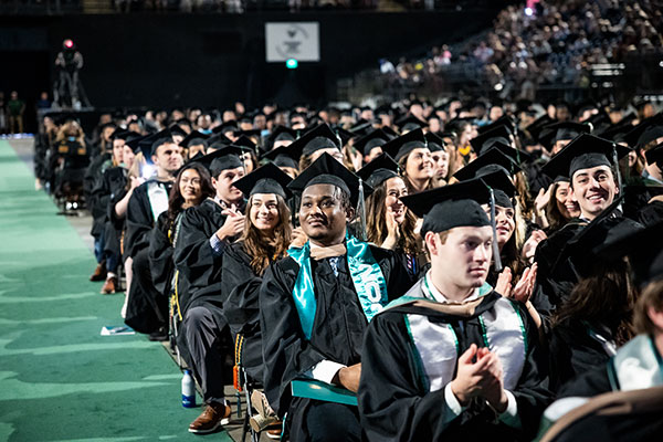 students sit at commencement exercises