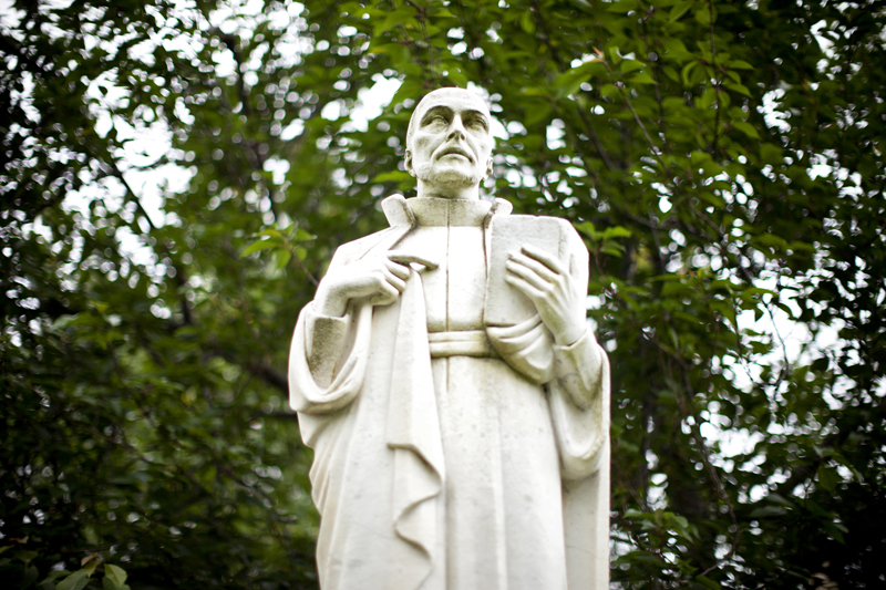 St. Ignatius statue with trees behind