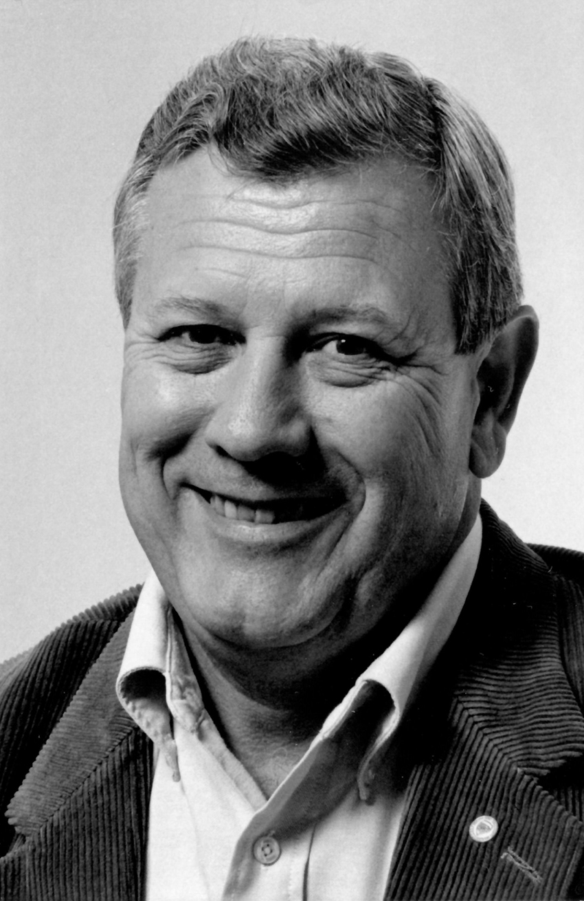 Black and white headshot of Graham, smiling.